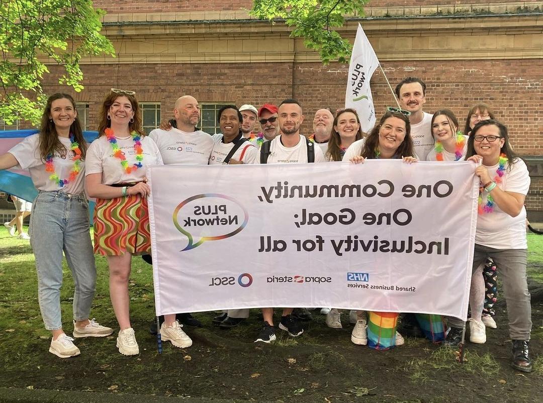 Members of our PLUS network holding a flag