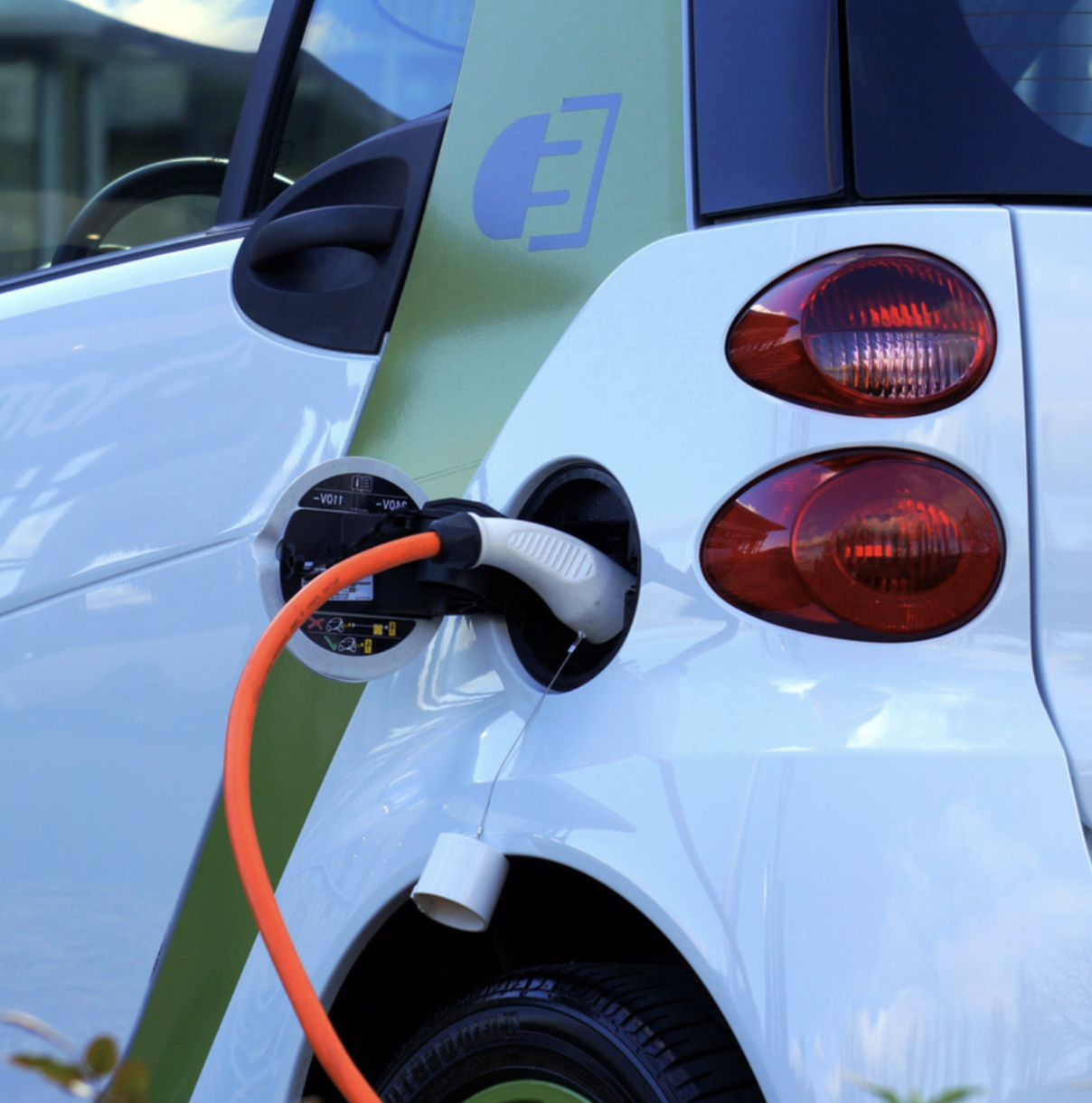 An electric smart car being charged.